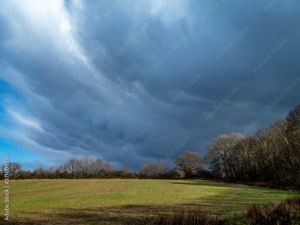 storm clouds gathering over the farmland