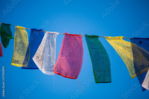 Фотография Some buddhist prayer flags, flying in the wind in Kathmandu, Nepal