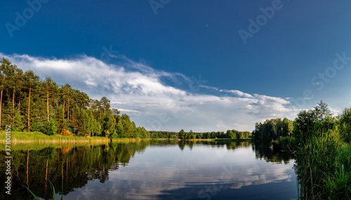 Fototapeta Naklejka Na Ścianę i Meble -  Beautiful lake in the woods with pine trees on the shore for summer vacation. Travel to Ukraine.