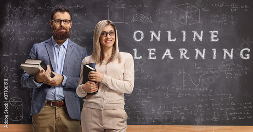 Male and female teachers in front of a blackboard with text online learning