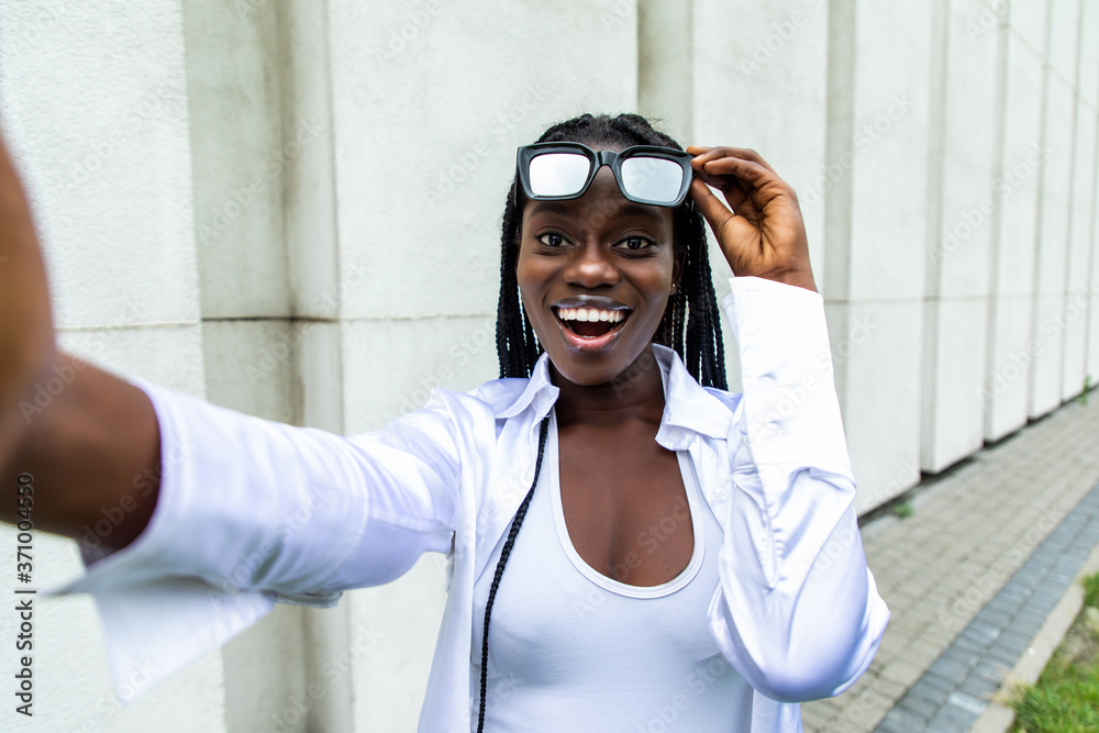 Portrait of an attractive young african american woman taking a selfie with her mobile phone