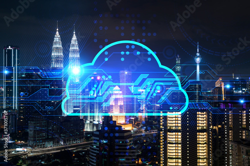 Information cloud hologram  aerial panoramic cityscape of Kuala Lumpur at night. The concept of secure storing digital data in KL  in Malaysia  Asia. Multi exposure.