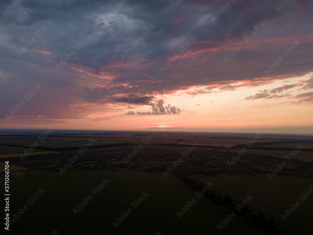 Aerial view. Sunset over Ukrainian agricultural fields.