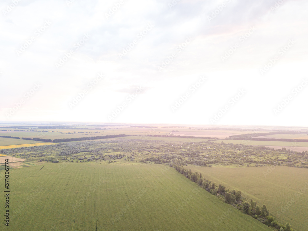 Aerial view. Sunset over Ukrainian agricultural fields.