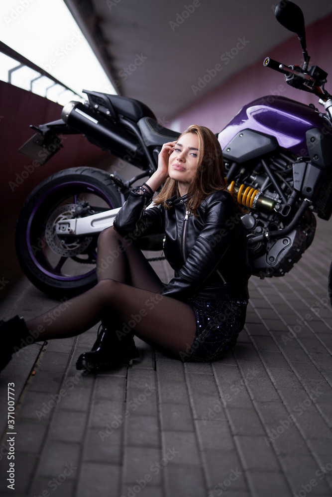 Naklejka premium Sport urban lifestyle. A motorbike with his female owner. Happy and beauty woman.