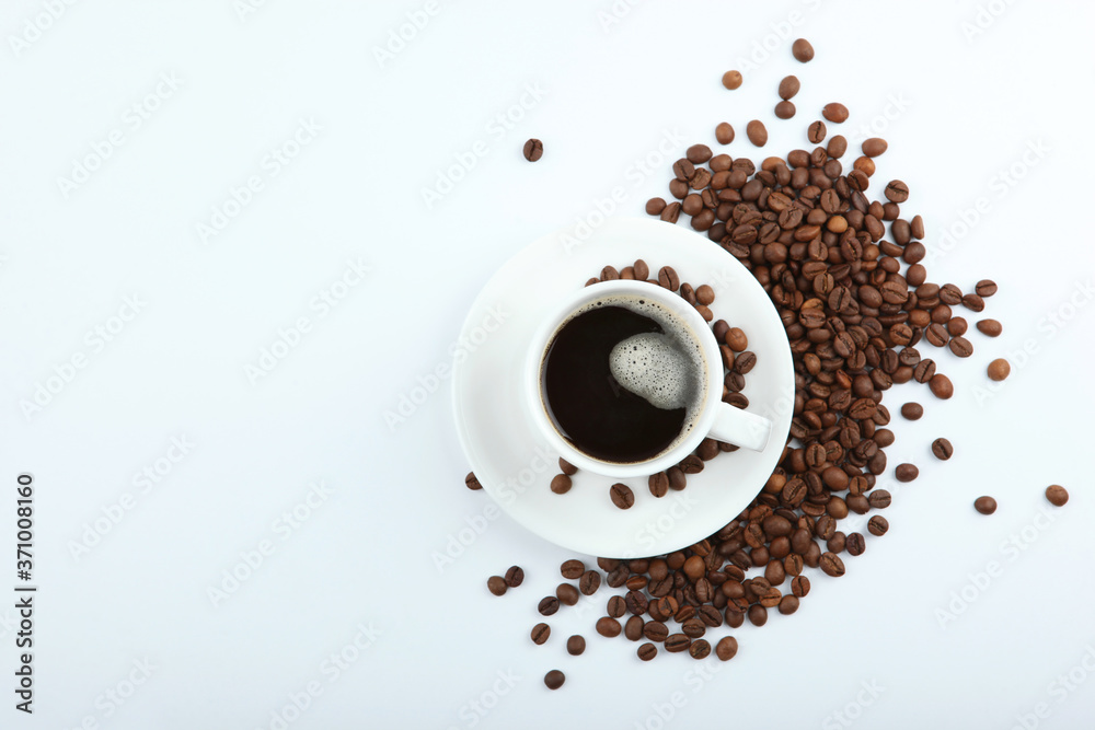 Fototapeta coffee beans and coffee cup on colored background with place for text