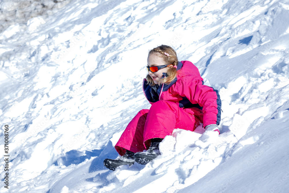 Young Girl Glides Down On The Snow Mountain.
