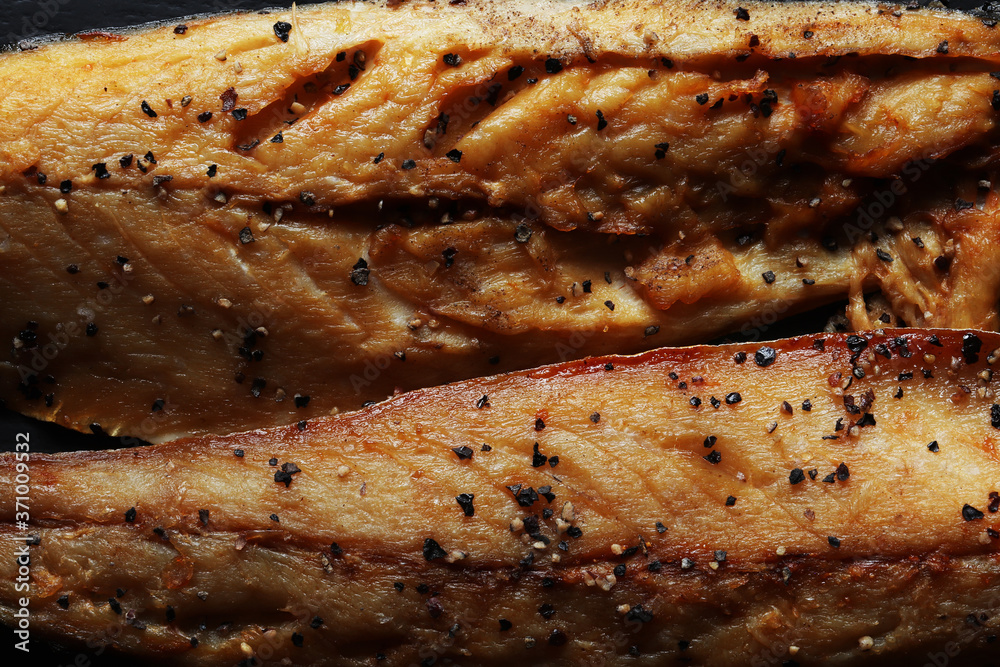 Photography of two fillets of smoked mackerel with ground black pepper for food illustrations Photography of two fillets of smoked mackerel with ground black pepper for food illustrations