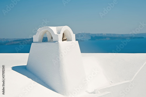 Chimney in Oia on Santorini island in Greece with caldera view at background
