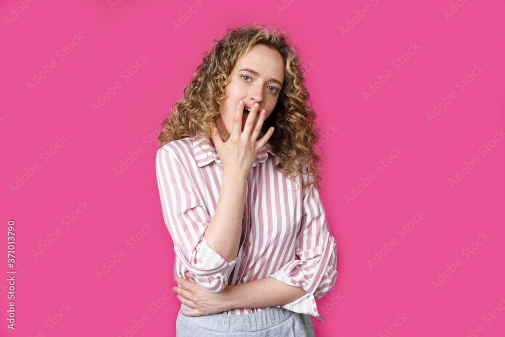 Young beautiful woman covers her face with her hand. Surprised look. Young beautiful woman covers her face with her hand. Surprised look.