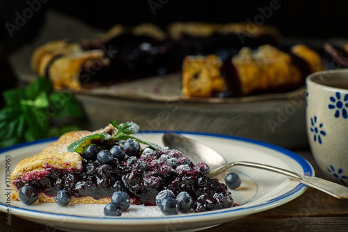 Piece of homemade blueberries galette on dish