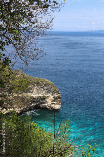 Top View of Suwehan beach on Nusa Penida Island, Bali, Indonesia. Amazing view, green plants, white sand beach with rocky mountains and azure lagoon with clear water of Indian Ocean 