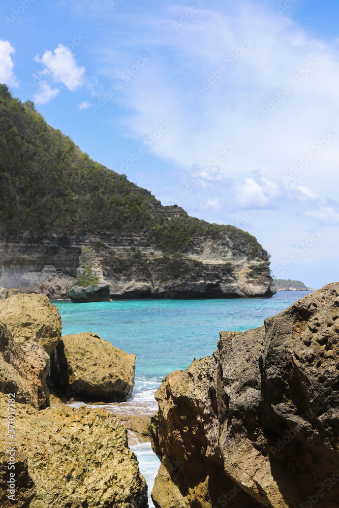 Suwehan beach on Nusa Penida Island, Bali, Indonesia. Amazing  view, white sand beach with rocky mountains and azure lagoon with clear water of Indian Ocean 