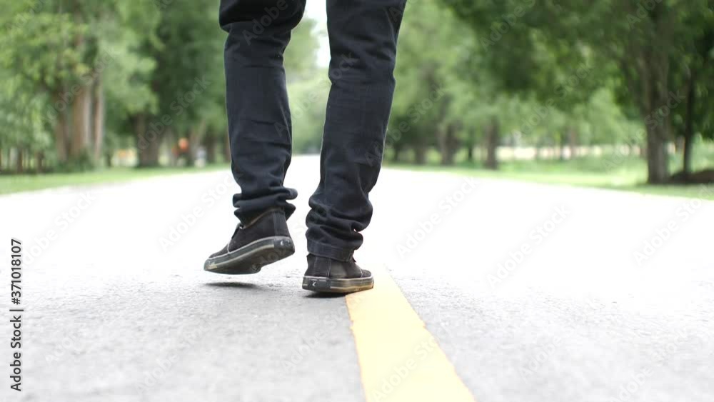 Asian man walking exercise on a beautiful road Asian man walking exercise on a beautiful road