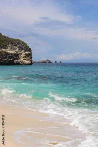 Suwehan beach on Nusa Penida Island, Bali, Indonesia. Amazing  view, white sand beach with rocky mountains and azure lagoon with clear water of Indian Ocean 
