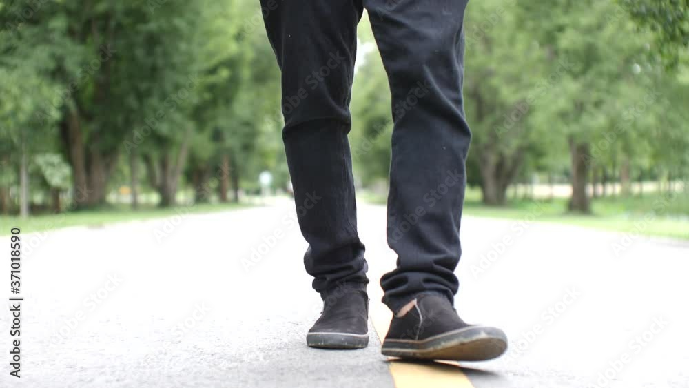 Asian man walking exercise on a beautiful road Asian man walking exercise on a beautiful road