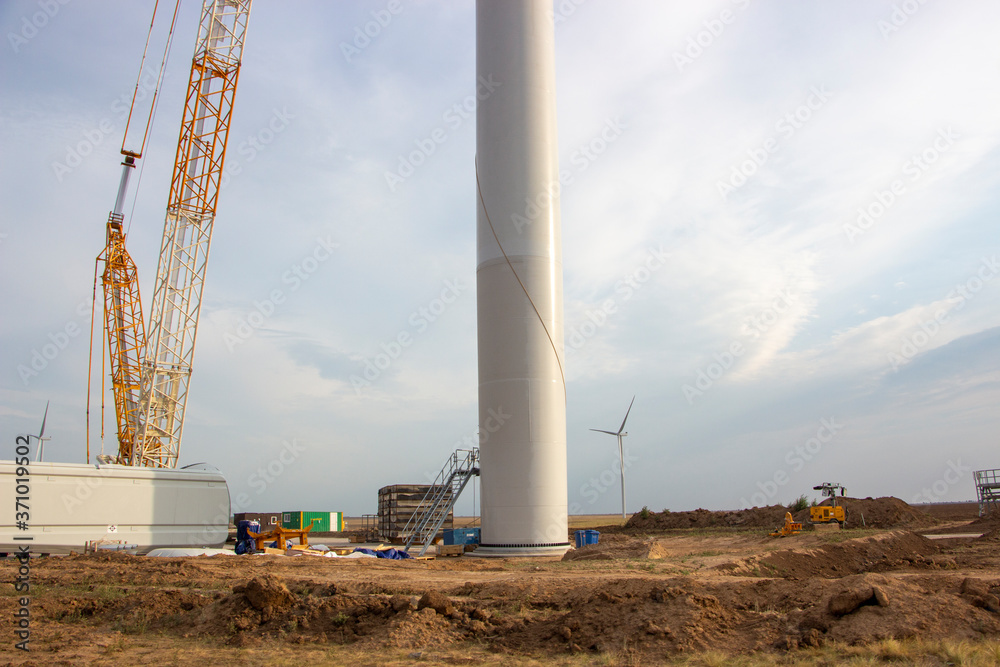 Wind turbine construction site, installation of a windmill crane. Ecological energy, modern technologies, construction of wind generators. Wind turbine construction site, installation of a windmill crane. Ecological energy, modern technologies, construction of wind generators.
