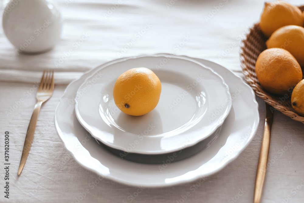 Table setting in white and yellow tones