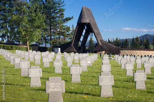 German military cemetery in autumn with mountains in the background and many graves of soldiers killed in the Second World War. Sunny day, Slovakia, Europe. photo