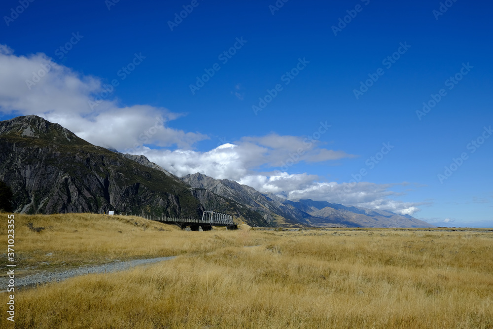 Mountain and farm on scenic road Queenstown New Zealand
