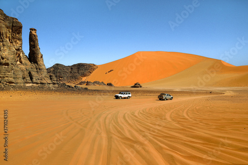 SAFARI IN THE SAHARA DESERT IN ALGERIA. NATIONAL PARK OF TADRART. SAND DUNES AND ROCK FORMATIONS. 