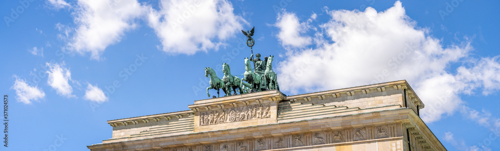 Brandenburg Gate with Quadriga statue as panorama background in summer, Berlin, Germany Brandenburg Gate with Quadriga statue as panorama background in summer, Berlin, Germany