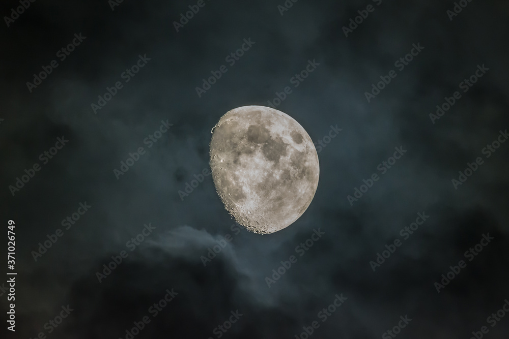 Waxing Gibbous phase moon with dark clouds Waxing Gibbous phase moon with dark clouds