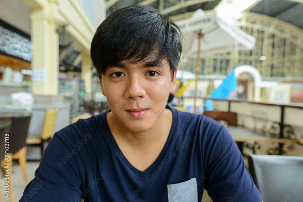 Young handsome Asian tourist man at the railway station Young handsome Asian tourist man at the railway station