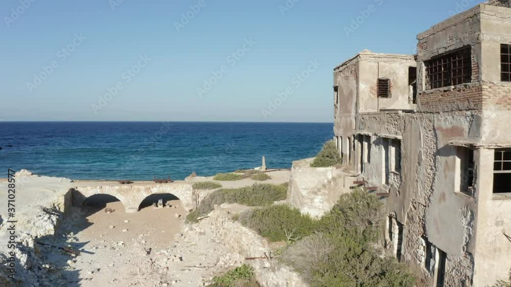 Aerial Dolly along Old Abandoned Factory Building at Beach on Milos Island, Greece Aerial Dolly along Old Abandoned Factory Building at Beach on Milos Island, Greece