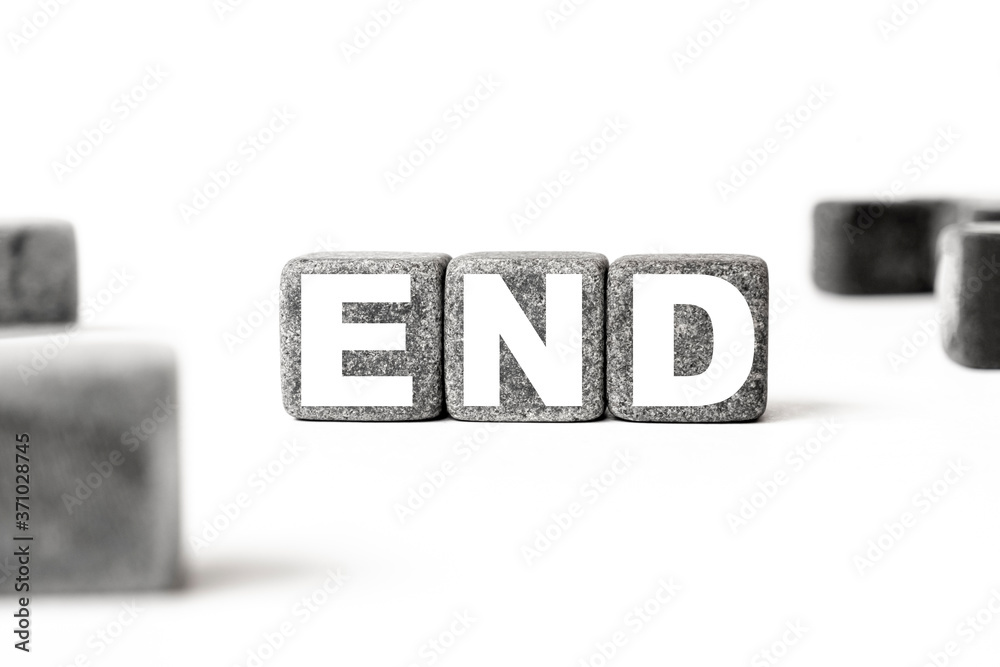 three stone cubes inscribed with the word end among the cubes on a white background. Strong business concept three stone cubes inscribed with the word end among the cubes on a white background. Strong business concept