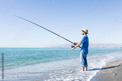 Man angling on the beach