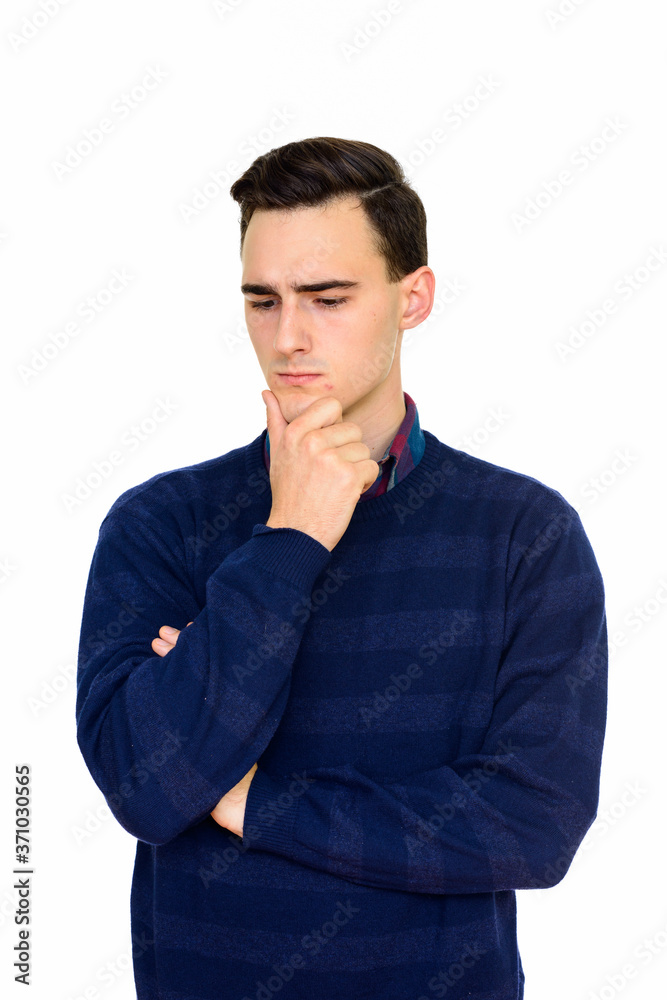 Studio shot of young serious Caucasian man thinking isolated against white background Studio shot of young serious Caucasian man thinking isolated against white background