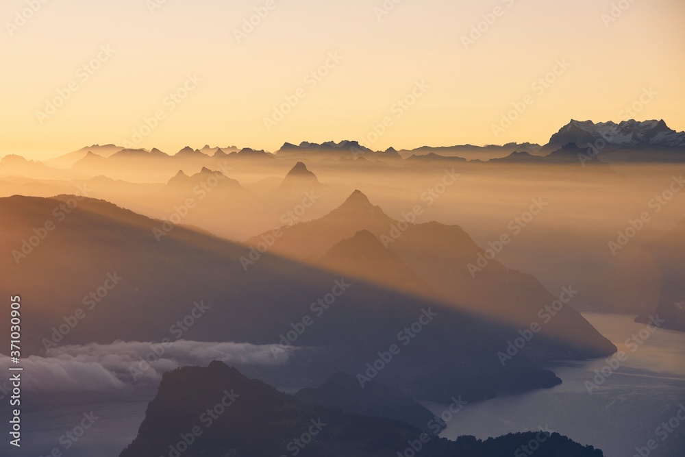 Scenic view of lake and mountains at sunrise