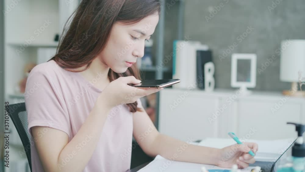 Freelance Asian woman work and quarantine at home office while corona virus prevention. New normal, lock down of Young beautiful businesswoman using smartphone talking, discussing online remote work. Freelance Asian woman work and quarantine at home office while corona virus prevention. New normal, lock down of Young beautiful businesswoman using smartphone talking, discussing online remote work.