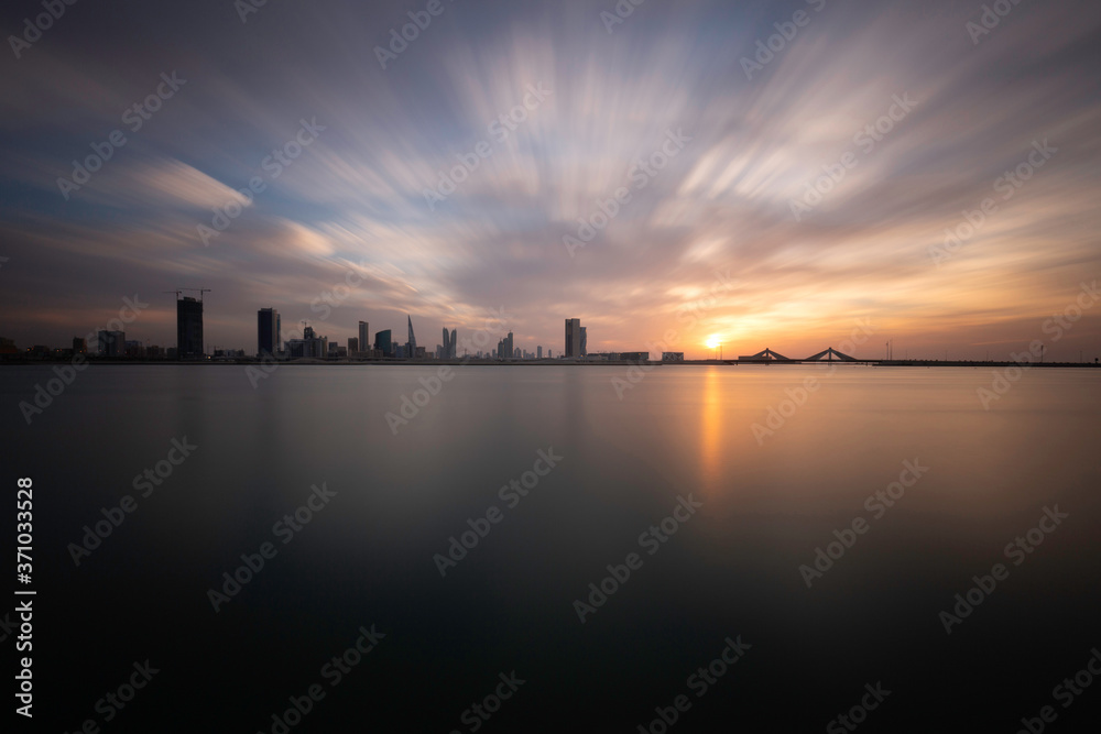 Bahrain skyline  with dramatic clouds during sunset