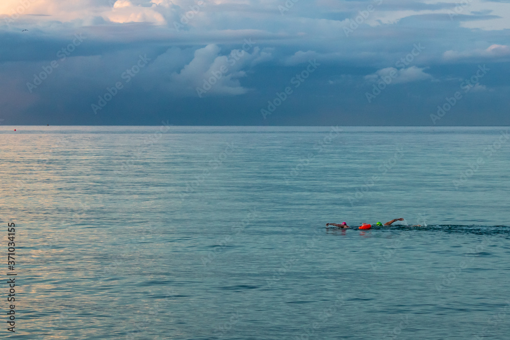 Two Swimmers in the Irish Sea at Dusk