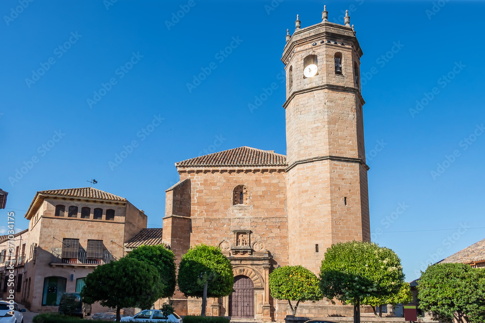 Facade and bell tower of church San Mateo, gothic and renaissance church, in old town of Banos de la Encina, Jaen, Andalusia, Spain