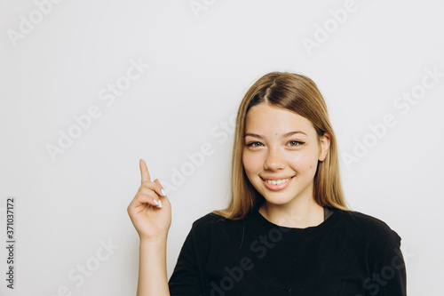 A teenage girl against grey background with copy space