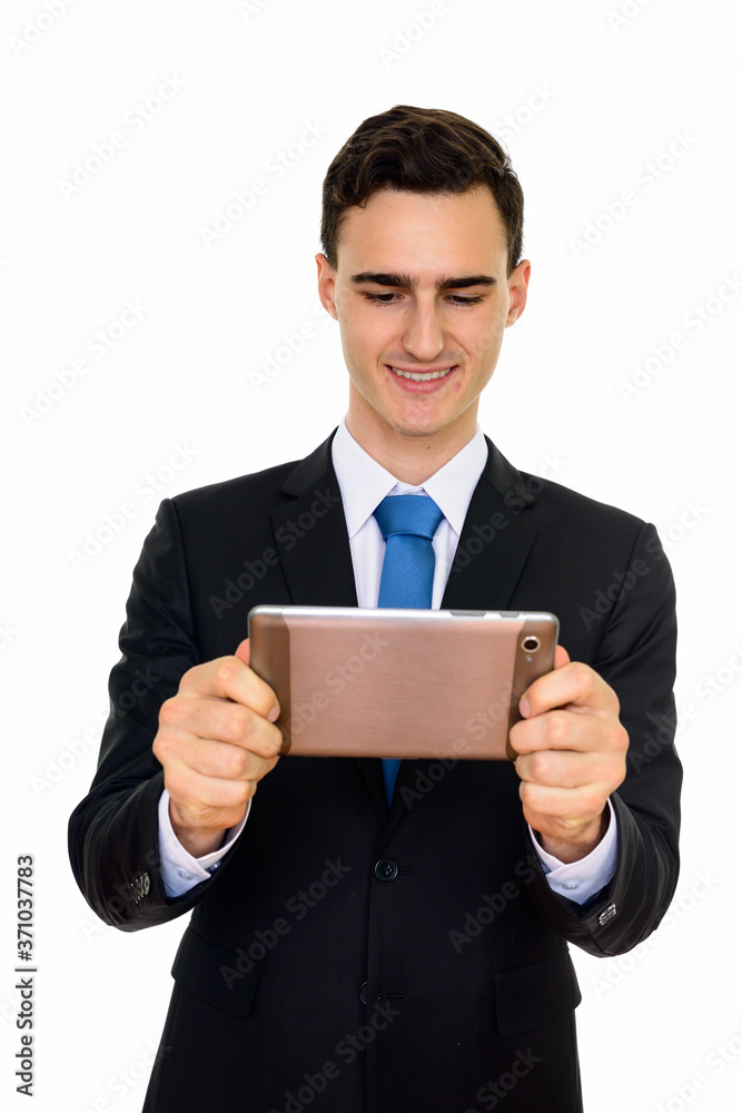 Portrait of happy young handsome businessman in suit