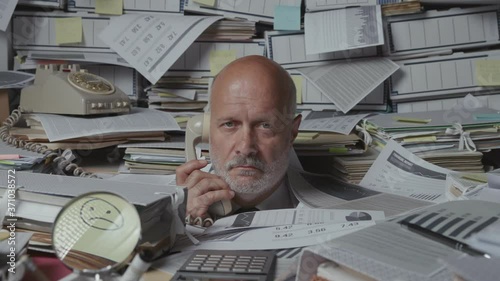 Sad frustrated business executive overwhelmed by work photo