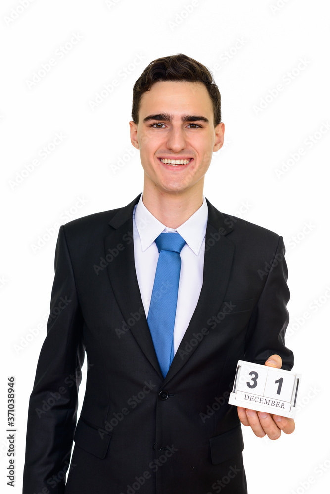 Studio shot of young handsome Caucasian businessman holding 31 December calendar isolated against white background Studio shot of young handsome Caucasian businessman holding 31 December calendar isolated against white background