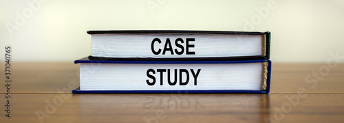 Books with text 'case study' on beautiful wooden table. White background. Business concept.