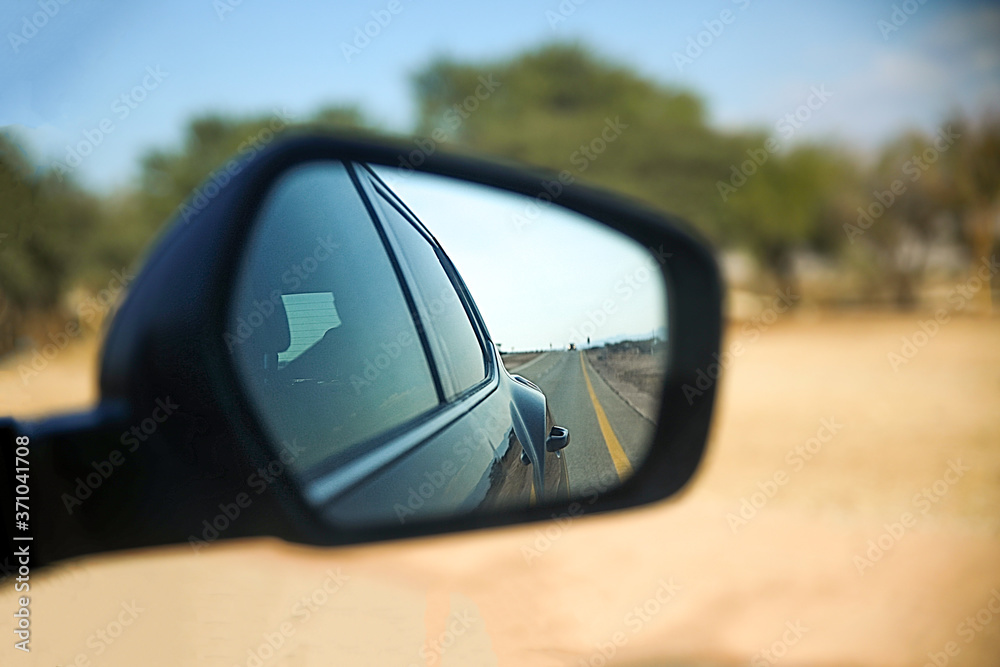 Road view through the car mirror