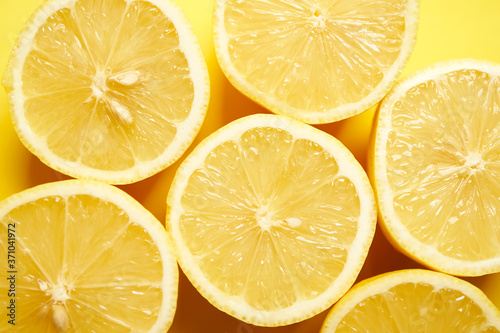 fresh lemons on a yellow minimalistic background