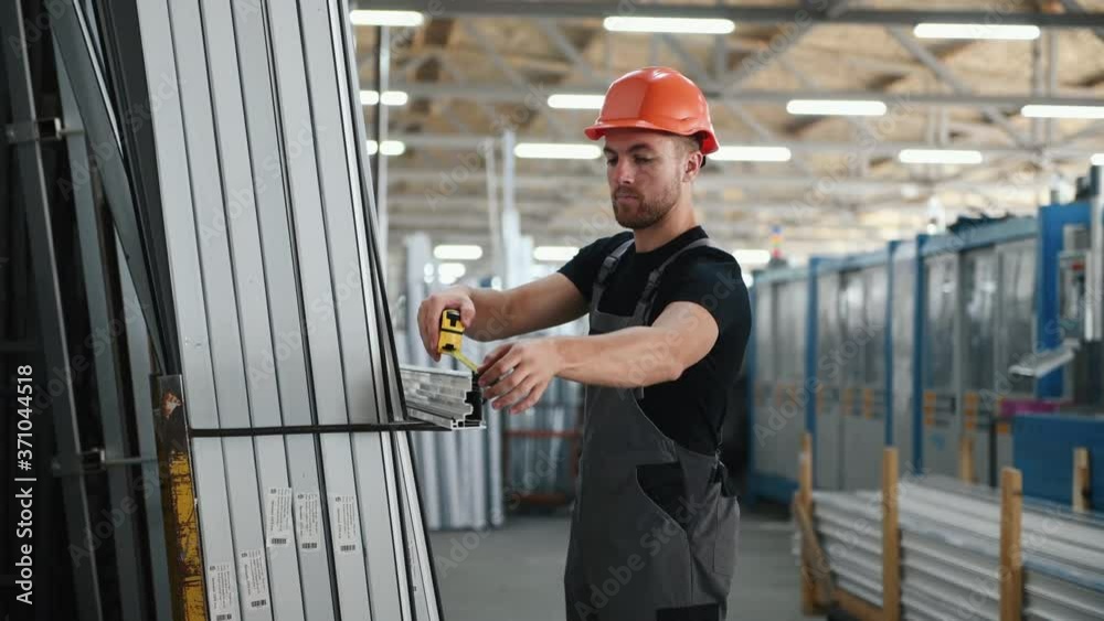 Industrial worker taking size data of piece from construction by using measuring roulette. Industrial worker taking size data of piece from construction by using measuring roulette.