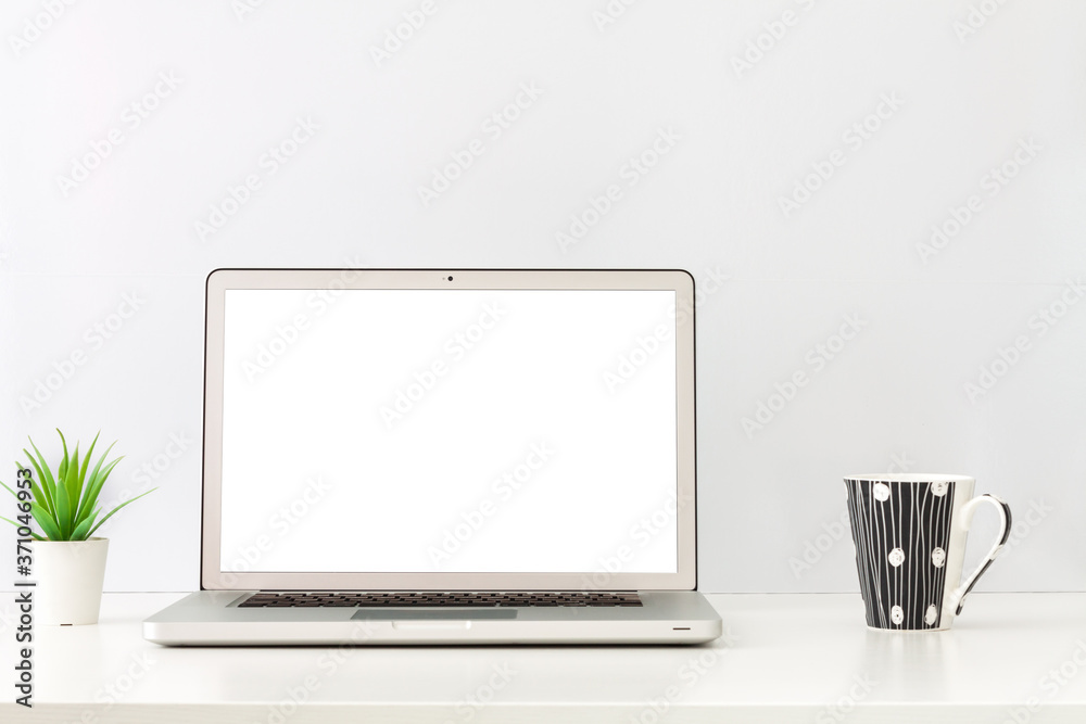 Fototapeta premium Business desk. Open laptop. Screen mockup. Minimal composition. One plant and a cup of coffee. Copy space.