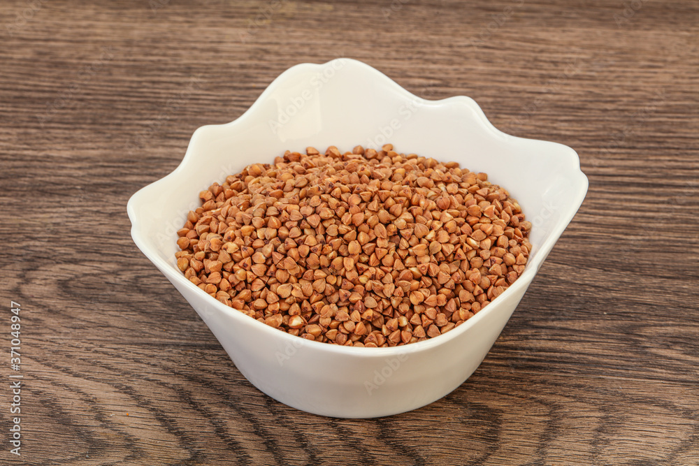 Raw buсkwheat cereal in the bowl Raw buсkwheat cereal in the bowl