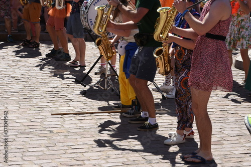 Fototapeta Naklejka Na Ścianę i Meble -  Street musicians with wind instruments and drums in color clothing in town of Colmar, France during weekend sunny summer day to cheer up tourists.
