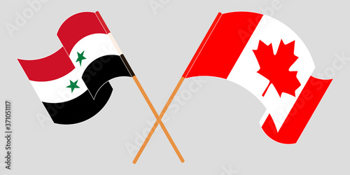 Crossed and waving flags of Syria and Canada
