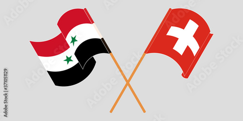 Crossed and waving flags of Syria and Switzerland